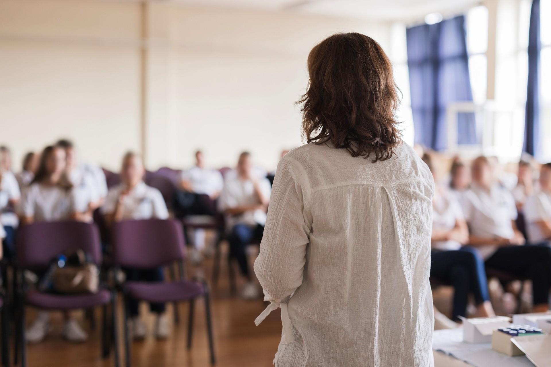 Rear-view of a woman having a lecture